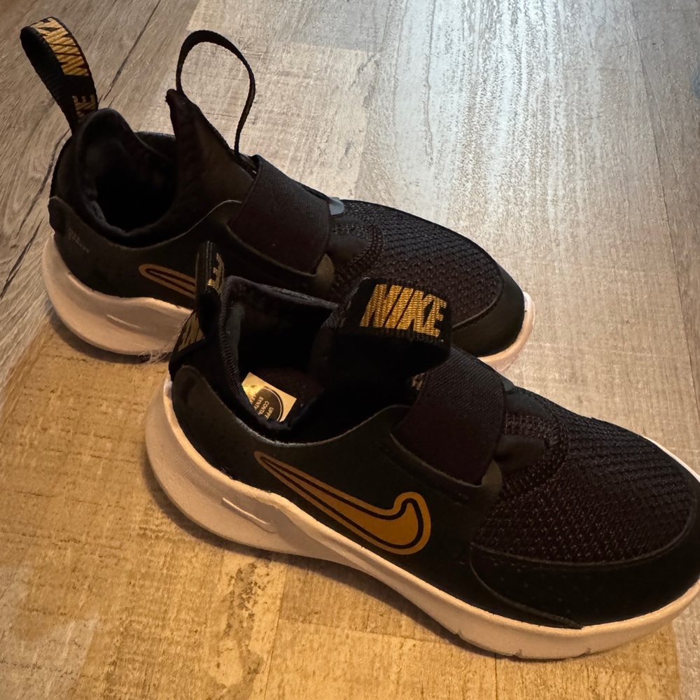 Nike Kids Black Sneakers with Gold Accents
